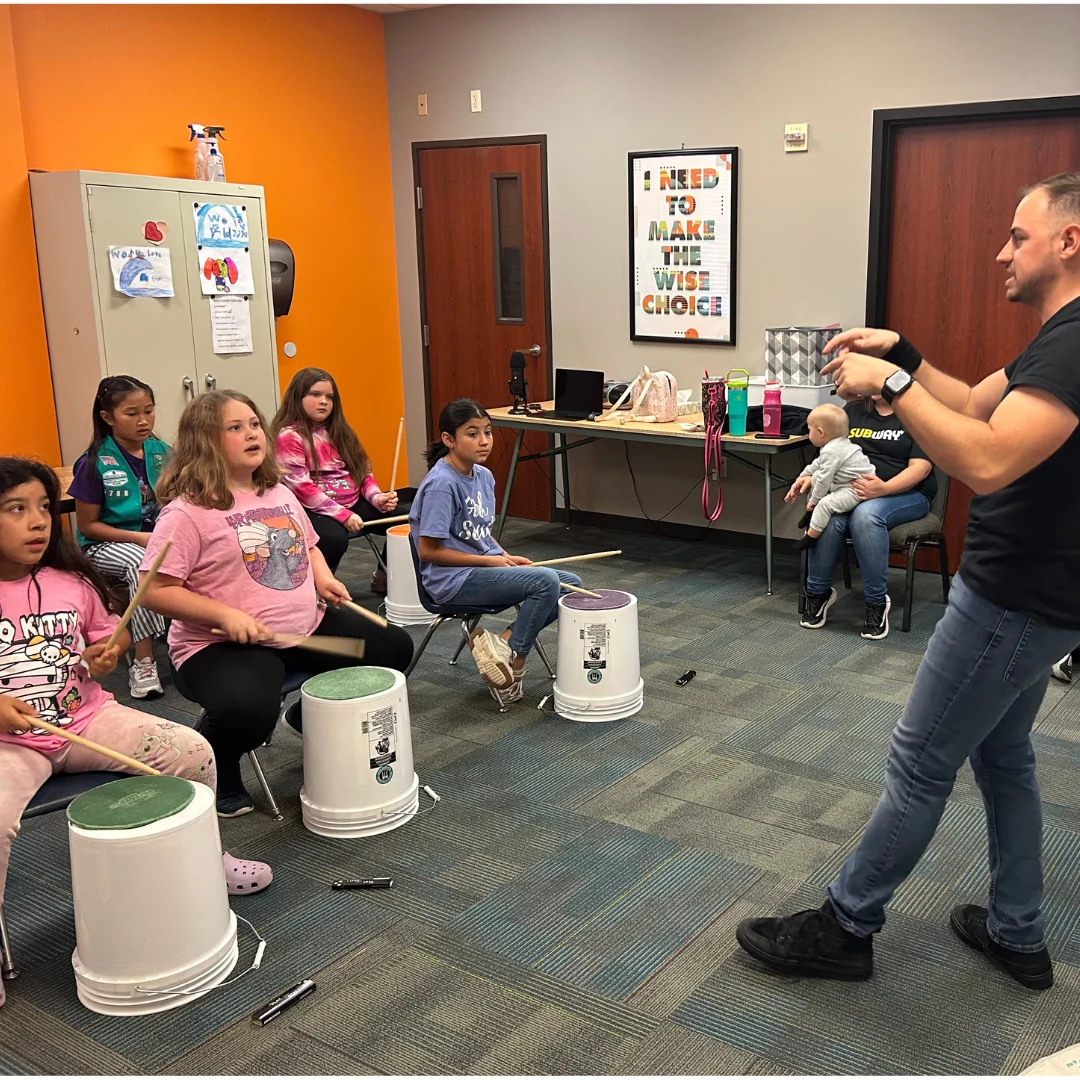 Mr. Garrett teaching rhythm to a group of young students